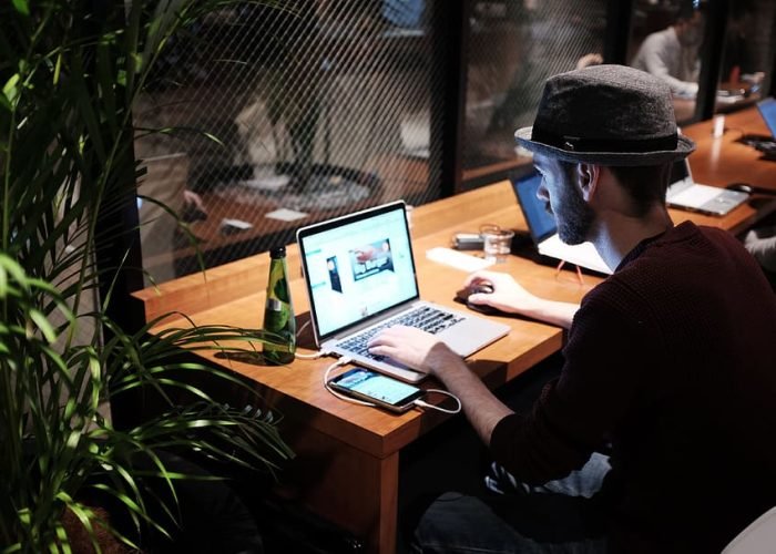 desk-hat-macbook-man